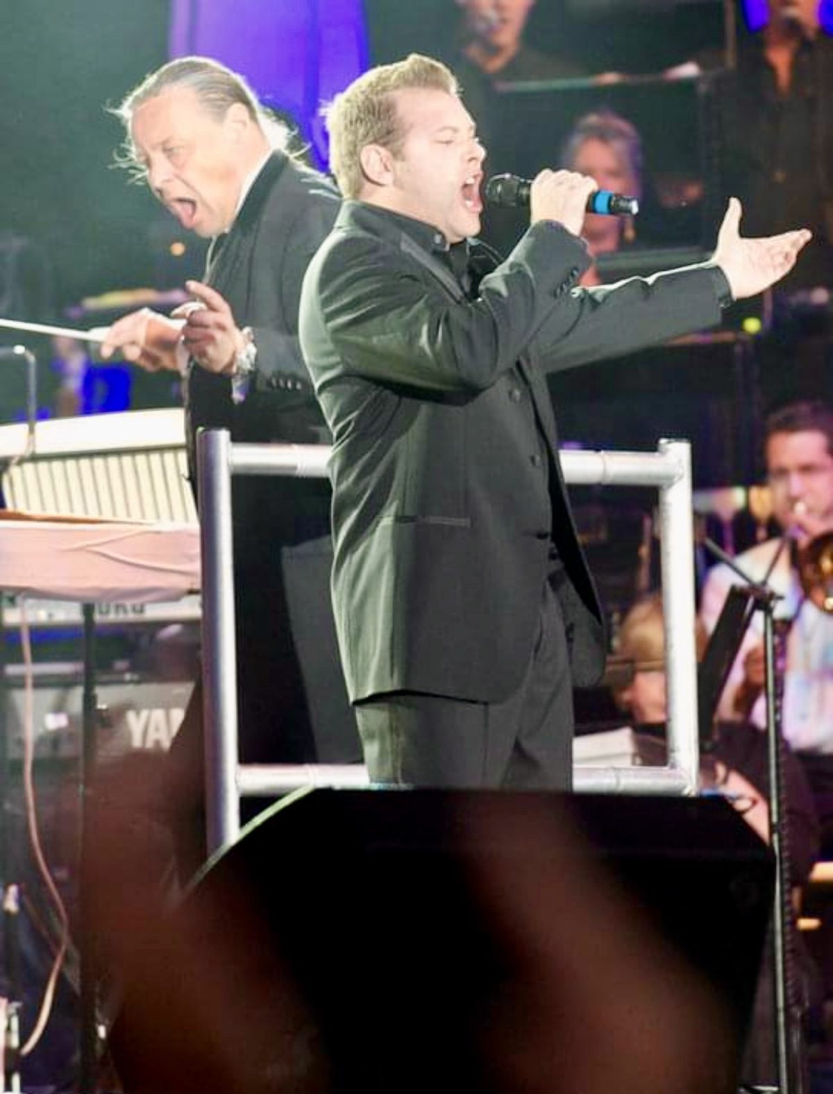 Jason Prendergast performing on stage.