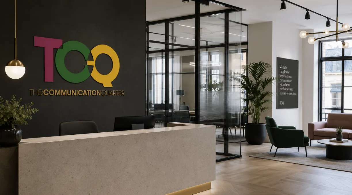 The Communication Quarter London office reception with glass meeting rooms and TCQ branding